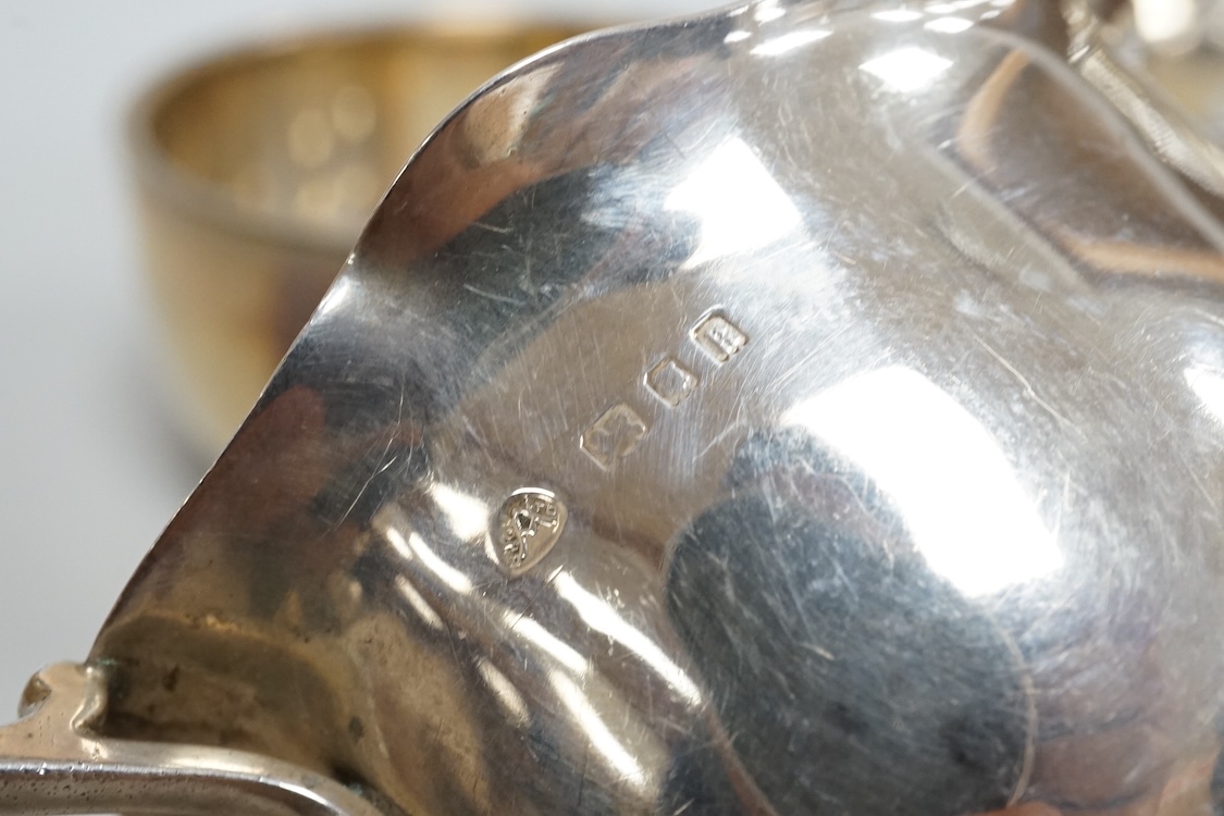 Two George V silver sauceboats, one by Asprey & Co, a silver pepperette, a silver bowl and a modern silver sugar caster, 16oz.